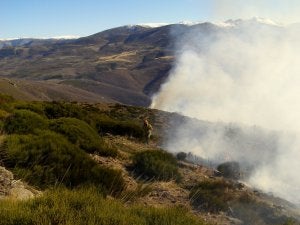 Un bombero forestal trabaja en la extinción de un incendio ocurrido el mes pasado en el Valle del Jerte. Al fondo se ven las crestas nevadas. :: HOY/